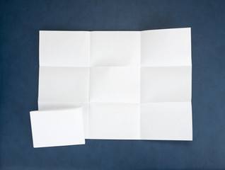 White sheet of paper folded in nine top shooting.