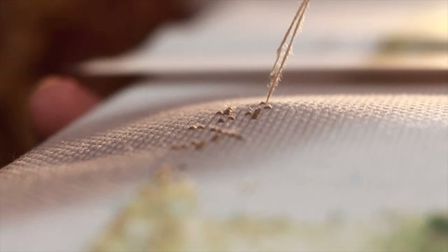 a needle pulling thread