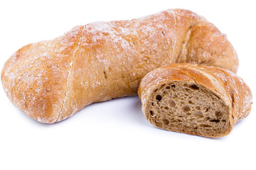 Tasty bread with slices on a white background.