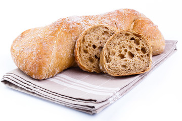 Tasty bread with slices on a white background.