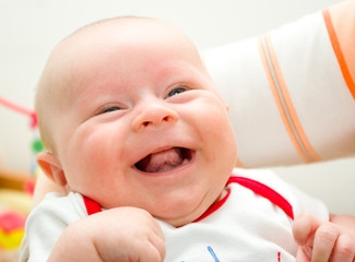 Funny laughing newborn european boy on a grandma hands - 81602066