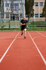 healthy man run on athletics race sport track and representing c