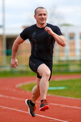 Fototapeta premium healthy man run on athletics race sport track and representing c