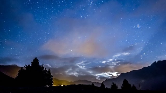 night sky stars moon fast clouds on mountain background Moonrise