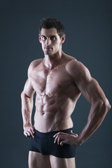 Fototapeta premium Portrait of a young sexy shirtless muscular man in underwear