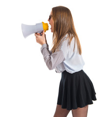 Pretty girl shouting by megaphone