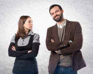 Couple with their arms crossed over isolated background