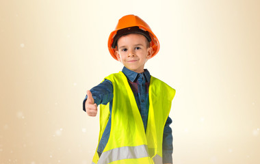 child dressed as a workman with thumb up