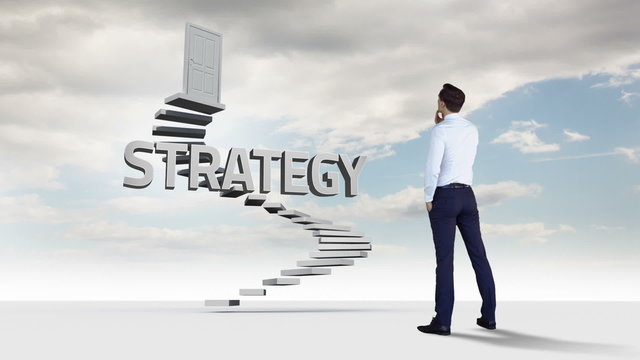 Businessman looking at steps with a floating word