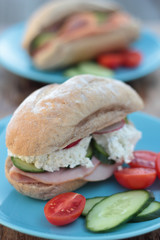 Freshly prepared sandwich with ham, veggies and cottage cheese.