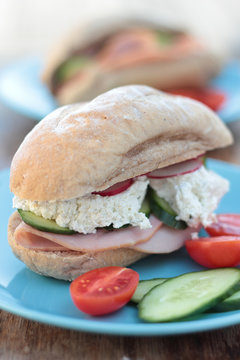 Freshly prepared sandwich with ham, veggies and cottage cheese.