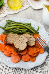 Italian veal meatloaf polpettone with carrots and sauce