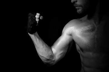 Obraz na płótnie Canvas Close up Muscular Arm on Black Background
