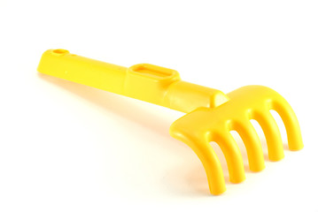 Yellow rake isolated on white background
