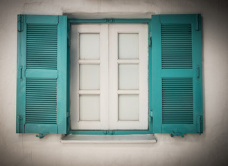 Fototapeta premium Open blue and white wooden window in Greece in retro style