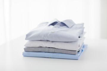 Fototapeta na wymiar close up of ironed and folded shirts on table