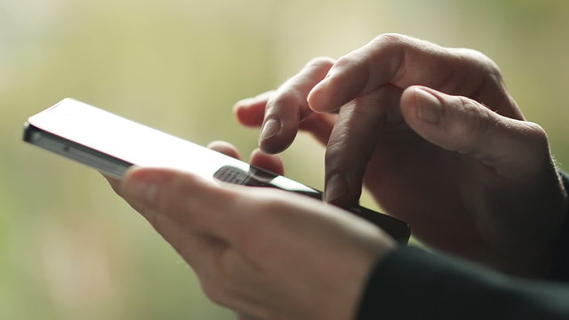 Business woman writes a message on Smartphone