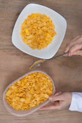 Cornflakes in porcelain bowl isolated on white background