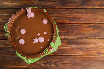 Farm themed chocolate cake on wooden table