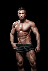 Fototapeta na wymiar very muscular handsome athletic man on black background, naked t
