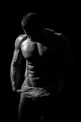 Obraz na płótnie Canvas very muscular handsome athletic man on black background, naked t