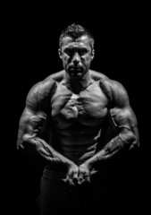 Fototapeta na wymiar bodybuilder, posing on a black background