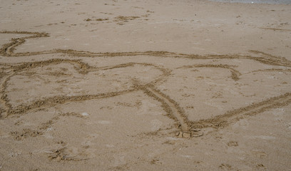 Abstract background with two big hearts drawn on beach