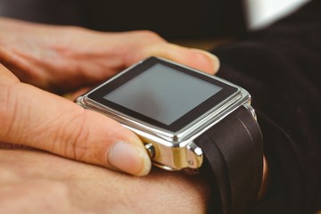 Businesswoman using her smart watch
