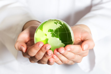 Environmental protection concept with glass globe in hand