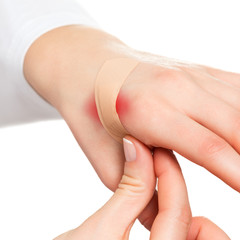 Hand and plaster on hurt skin
