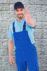 Composite image of repairman gesturing thumbs up