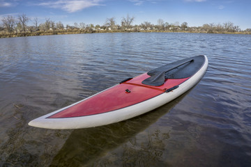SUP paddleboard on lake shore