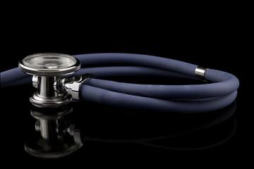 Studio shot of stethoscope with reflection in black background