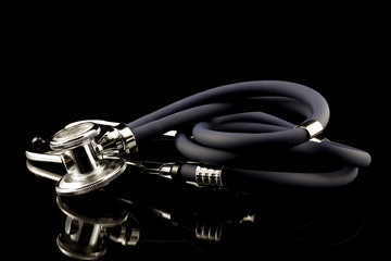 Studio shot of stethoscope with reflection in black background