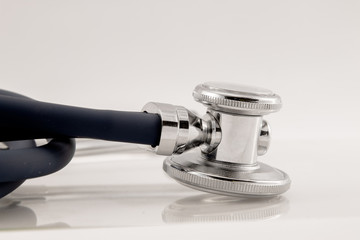 Studio shot of stethoscope detail with reflection in white back