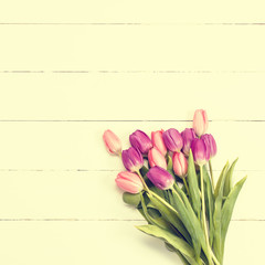 Tulips on wooden texture