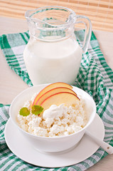 Cottage cheese with apples and sour cream for breakfast close up