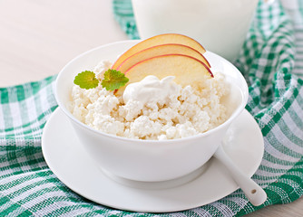 Cottage cheese with apples and sour cream for breakfast close up