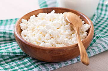 Cottage cheese with apples for breakfast in wooden bowl close up