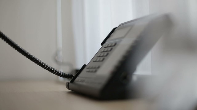 Phone in a hotel room or office. Close up