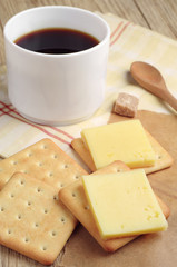 Cracker with cheese and coffee