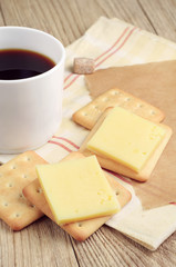 Coffee and cracker with cheese