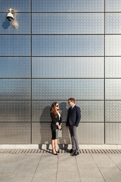 Business Couple Talking in the Street Besides a Financial Area