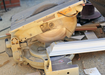 Obraz na płótnie Canvas Carpenter cutting with miter saw