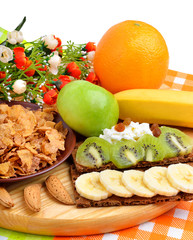 Healthy food. Fresh fruit and dry loaves with curd on a wooden b