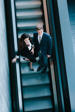 Business Couple in the Escalators