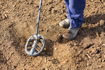 Man searching for treasure with metal detector
