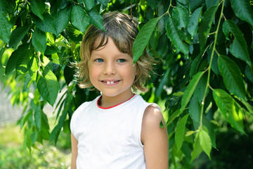 Little boy has fun in the summer rain, toned and noise added