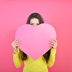 Love and valentines day woman holding heart and smiling over pin