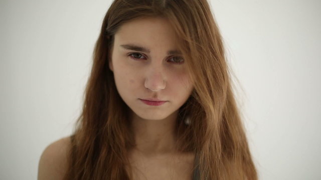 Unhappy sad woman isolated at white background